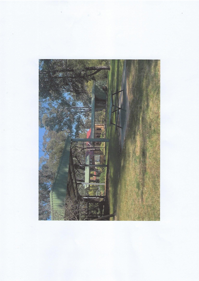 A green structure in a park

Description automatically generated