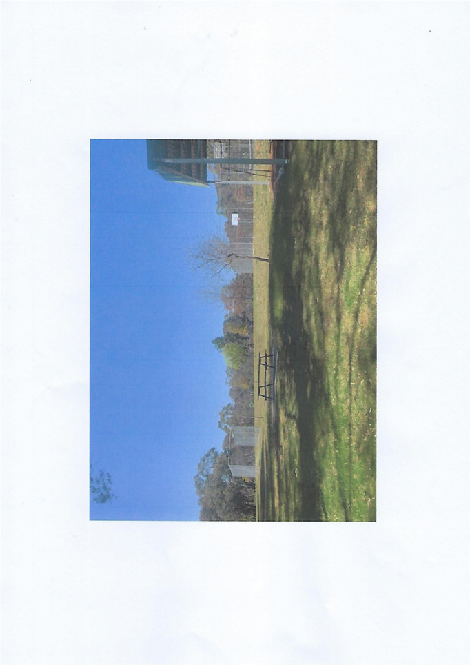 A park with a bench and a bench

Description automatically generated