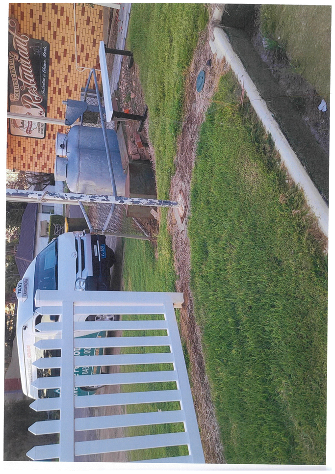 A white fence in front of a building

Description automatically generated